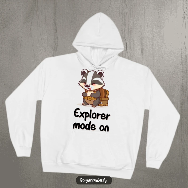 Funny badger hoodie showing a curious badger with a backpack peering excitedly into a treasure chest.