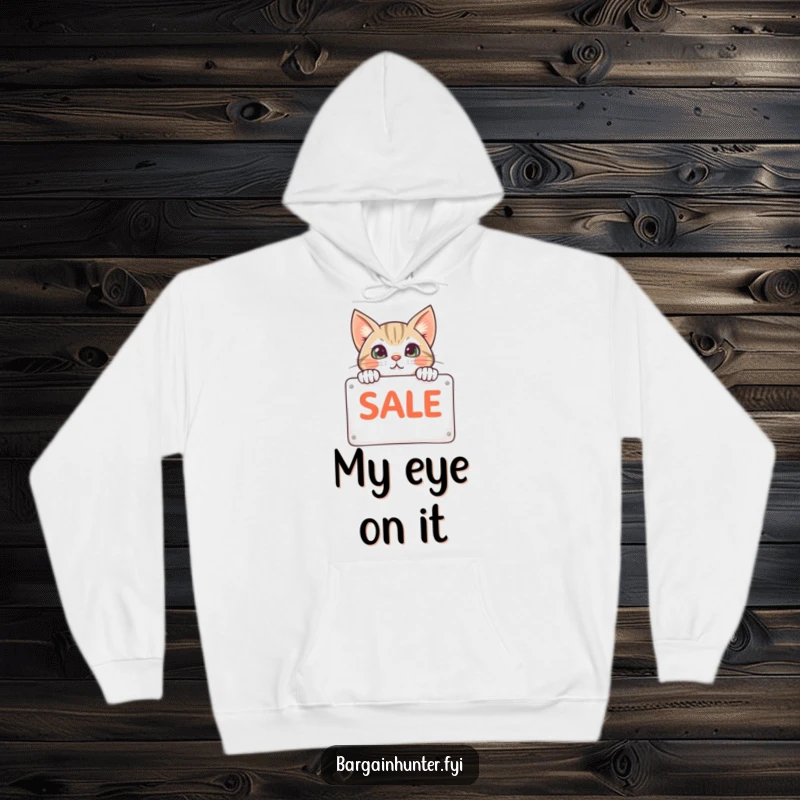 Funny cat peeking from behind a sale sign on a hoodie, exuding warmth and a love for shopping, ideal cozy wear.