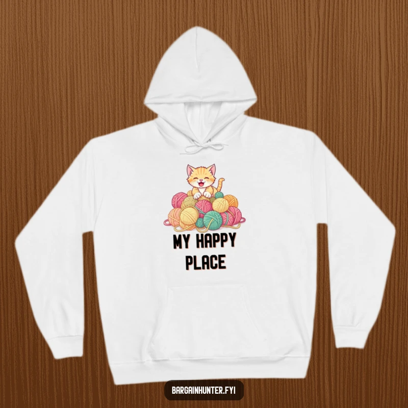 Funny kitten hoodie showing a playful kitten gleefully pouncing on a mountain of discounted yarn balls.